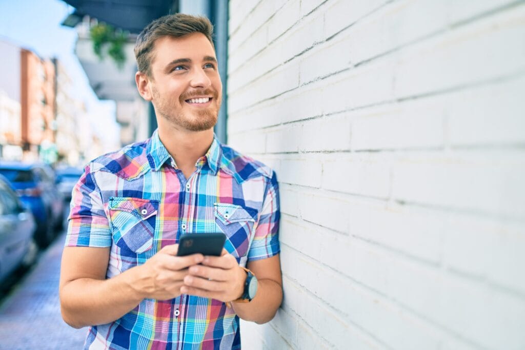 Happy man getting a mobile SIM card in Spain