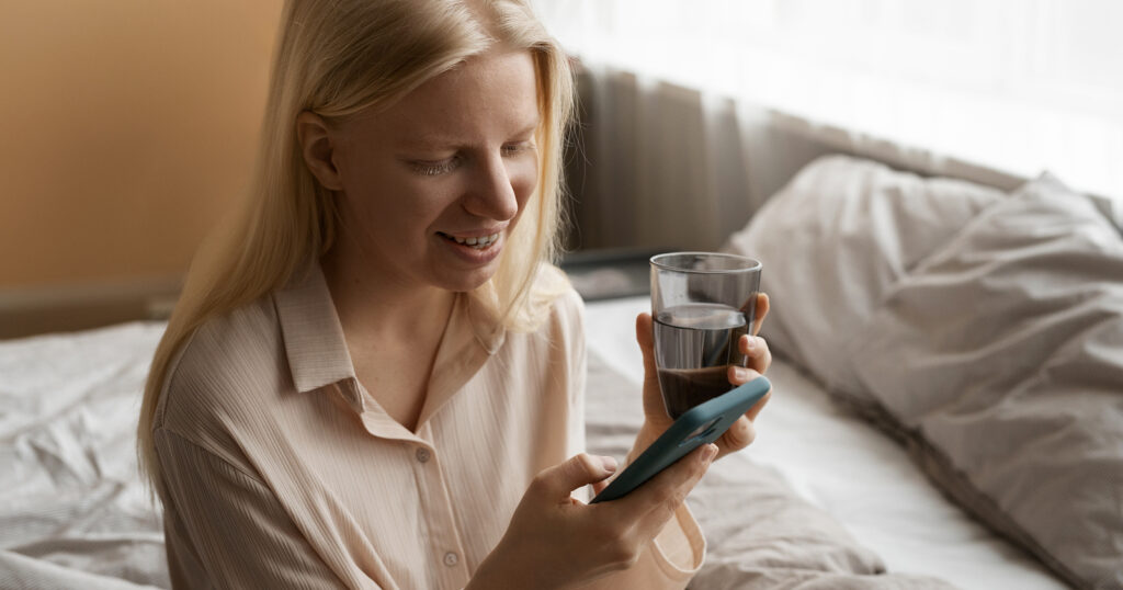 Woman holding a mobile phone calculating the data plans she needs each month Woman holding a mobile phone calculating the data plans she needs each month