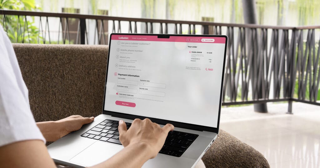 Lobster SIM Signup: Payment Details Person entering card payment details to complete their Lobster SIM order on a laptop